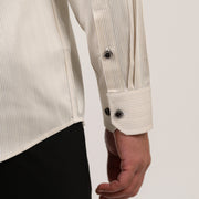 Adjustable dual-button cuff close up on beige striped formal shirt