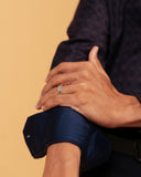 Folded cuff detail of wine and navy jacquard shirt on model