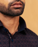 Half side collar view of wine and navy jacquard shirt on model