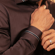 Cuff detail of dark brown Giza satin shirt on model