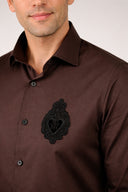Dark brown satin shirt with signature patch detail on chest