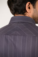 Texture close-up of luxury dark grey Giza satin fabric in herringbone weave
