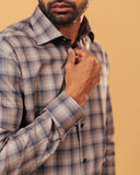 Cuff detail of dark grey plaid Giza twill shirt on model