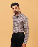 Model wearing dark grey plaid Giza twill shirt front view