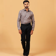 Model wearing dark grey plaid Giza twill shirt full front view