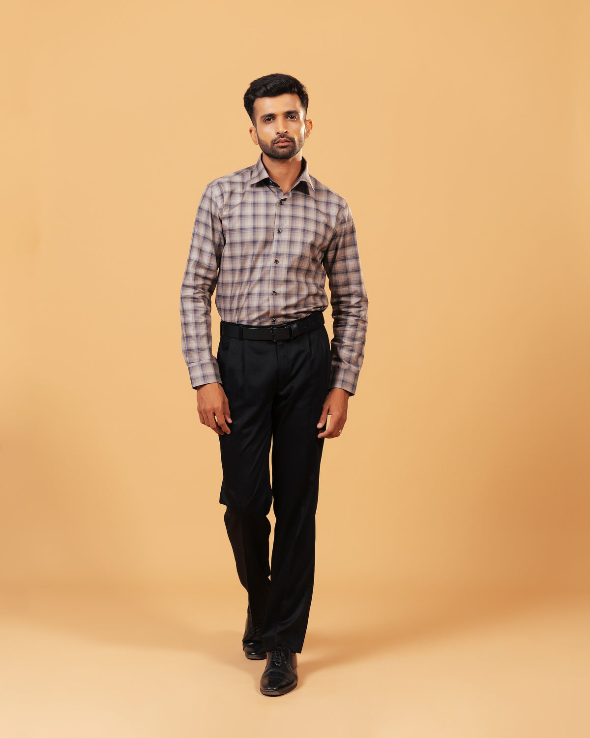 Model wearing dark grey plaid Giza twill shirt full front view
