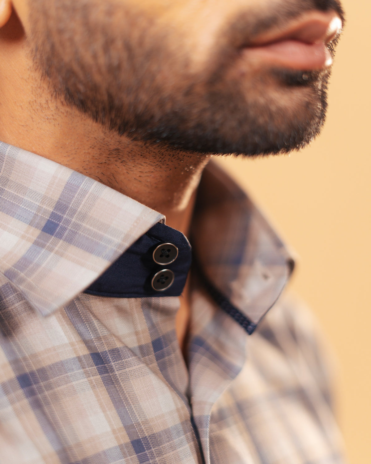 Half side collar view of dark grey plaid Giza twill shirt on model