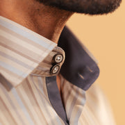 Half side collar view of earth tone satin stripe shirt on model