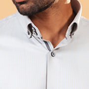 Model wearing ivory herringbone shirt front zoomed collar view