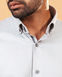 Model wearing ivory herringbone shirt front zoomed collar view