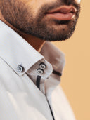 Half side collar view of ivory herringbone shirt on model