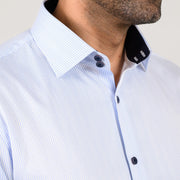 Light blue pinstripe shirt close-up with double-button collar and black collar tape