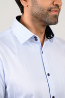 Light blue pinstripe shirt close-up with double-button collar and black collar tape