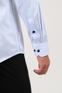 Two-button barrel cuff detail on light blue pinstripe satin shirt
