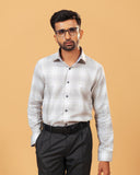 Model wearing light grey windowpane twill shirt front view