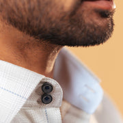Half side collar view of light grey windowpane twill shirt on model