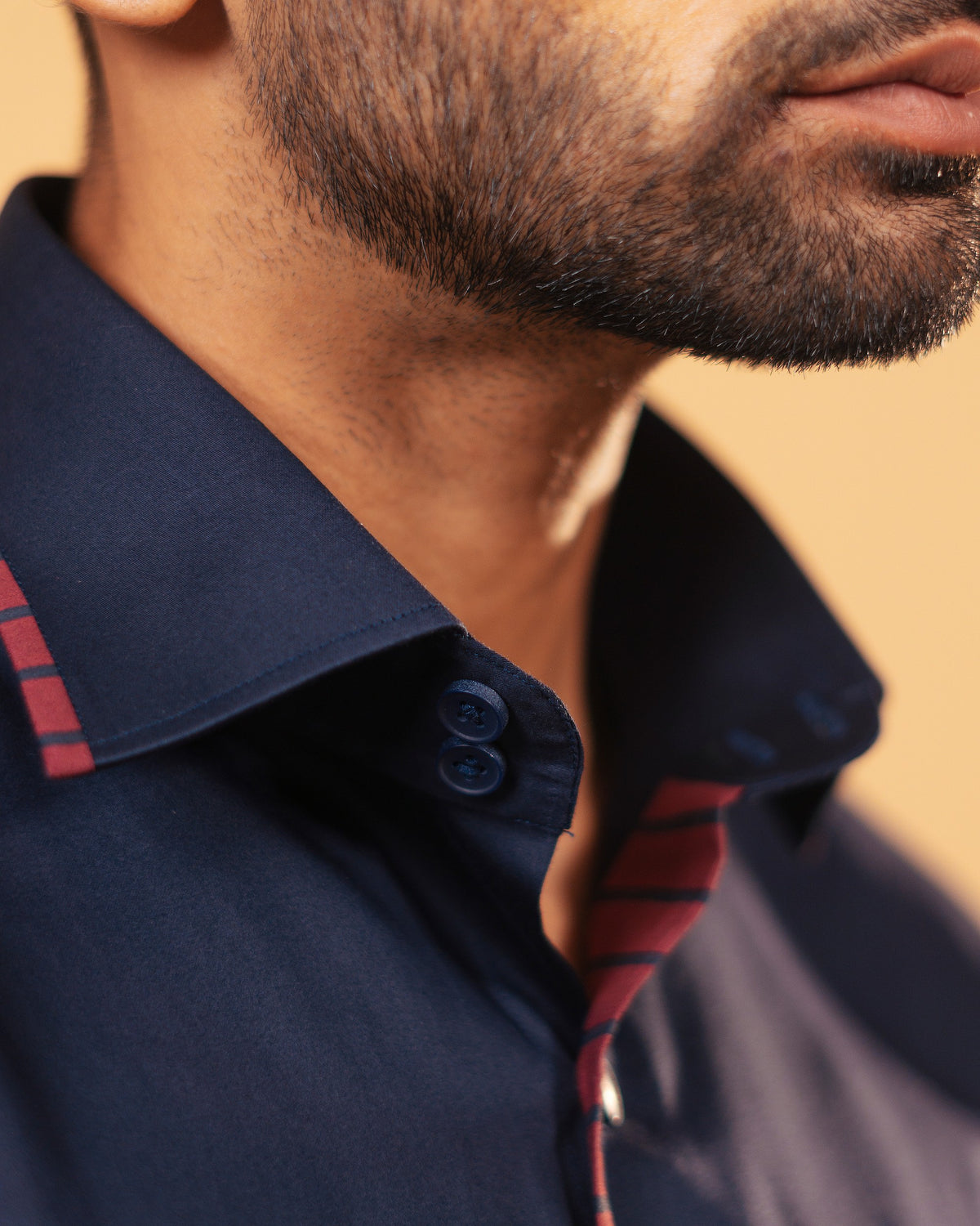 Half side collar view of navy blue Giza satin shirt on model
