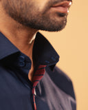 Placket detail of navy blue Giza satin shirt on model