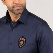 Navy blue pin stripe shirt with bold signature logo patch detail on left chest