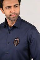 Navy blue pin stripe shirt with bold signature logo patch detail on left chest