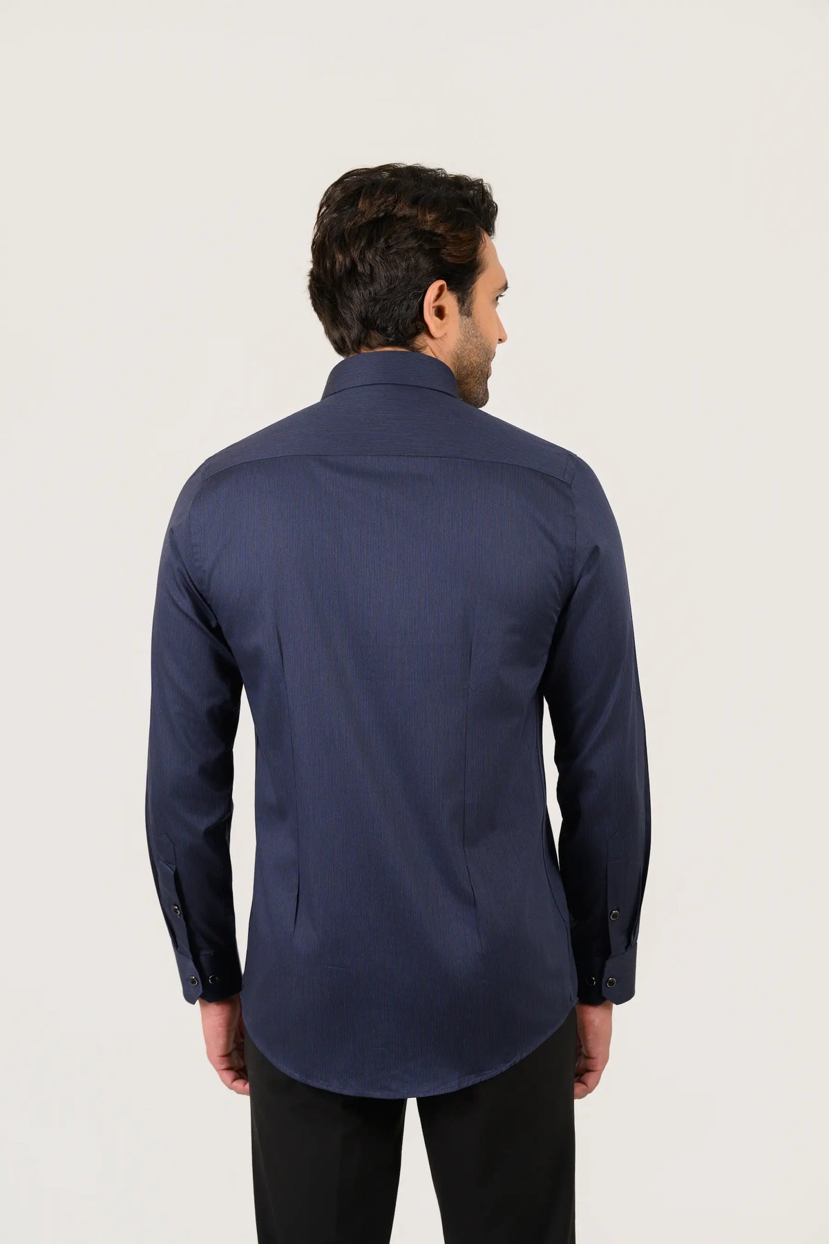 Navy blue pin stripe shirt for men worn by model showing full back view and tailored fit