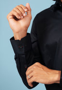 Cuff detail of black twill embroidered patch shirt on model