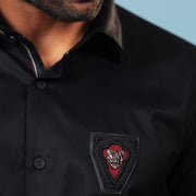 Embroidered signature patch detail of black twill shirt