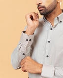 Cuff detail of olive and white Oxford houndstooth shirt on model