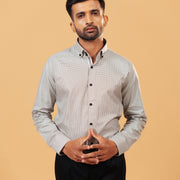 Model wearing olive and white Oxford houndstooth shirt half front view