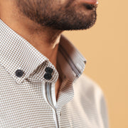 Side collar view of olive and white Oxford houndstooth shirt on model