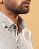 Side collar view of olive and white Oxford houndstooth shirt on model