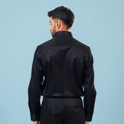 Model back view wearing black twill leather wolf patch shirt