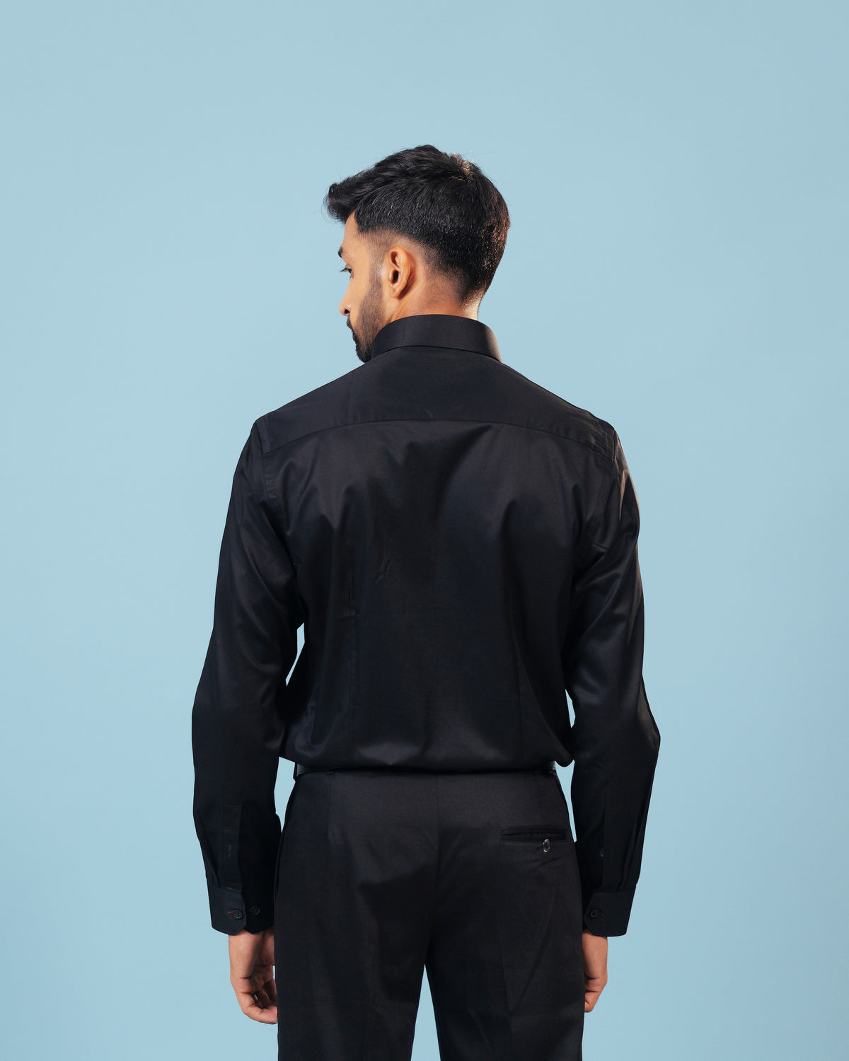 Model back view wearing black twill leather wolf patch shirt