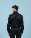 Model back view wearing black twill leather wolf patch shirt
