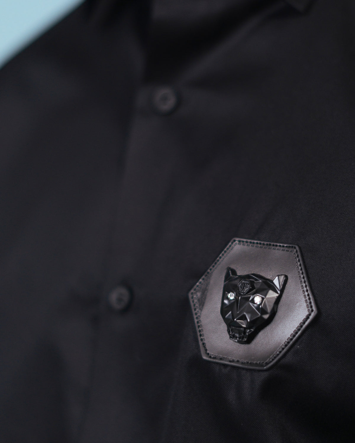 Leather wolf signature patch detail of black twill shirt