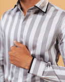 Cuff detail of silver wide stripe satin shirt on model
