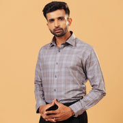 Model wearing light brown Giza twill check shirt front view