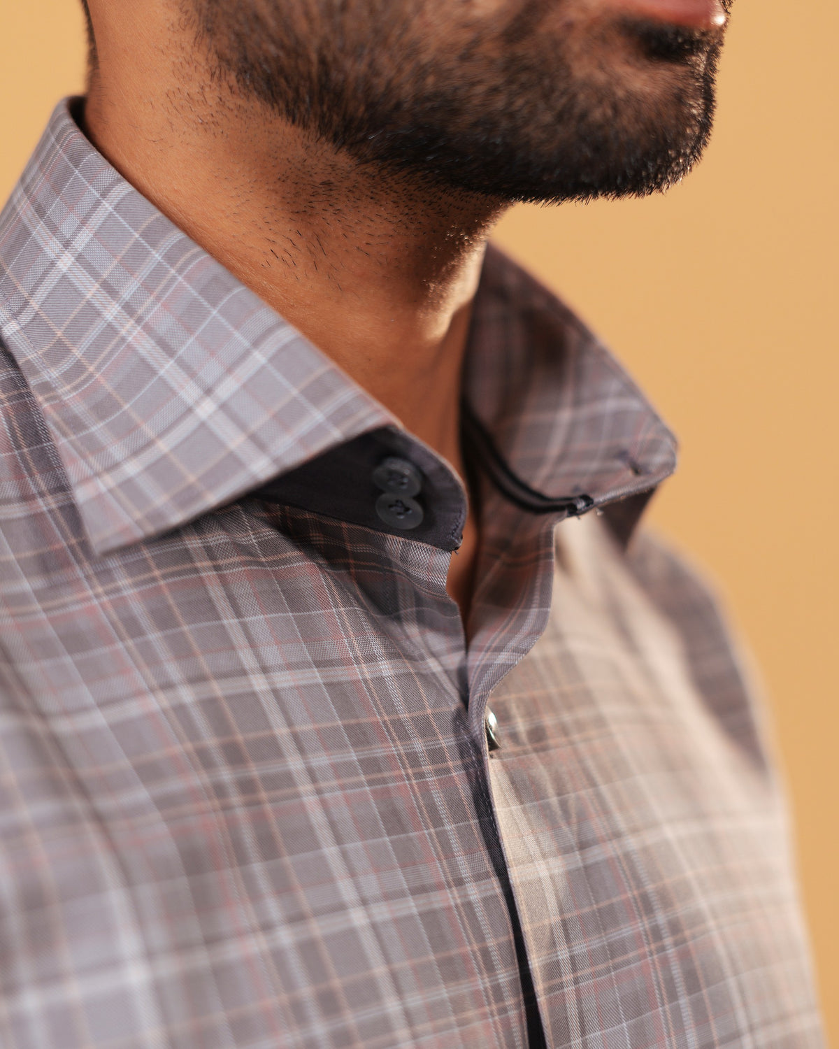 Half side collar view of light brown Giza twill check shirt on model