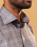 Half side collar view of light brown Giza twill check shirt on model