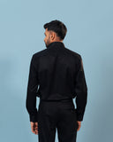 Model back view wearing black twill shirt