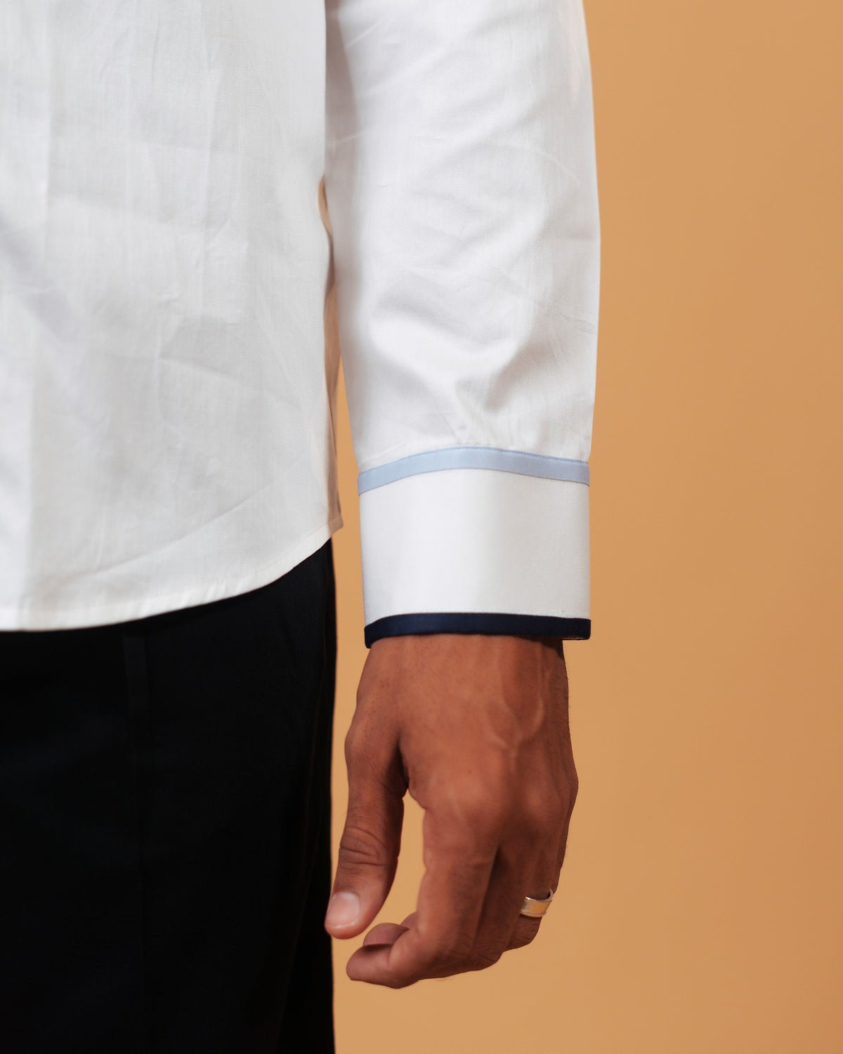 Zoomed cuff detail of white Giza satin shirt on model
